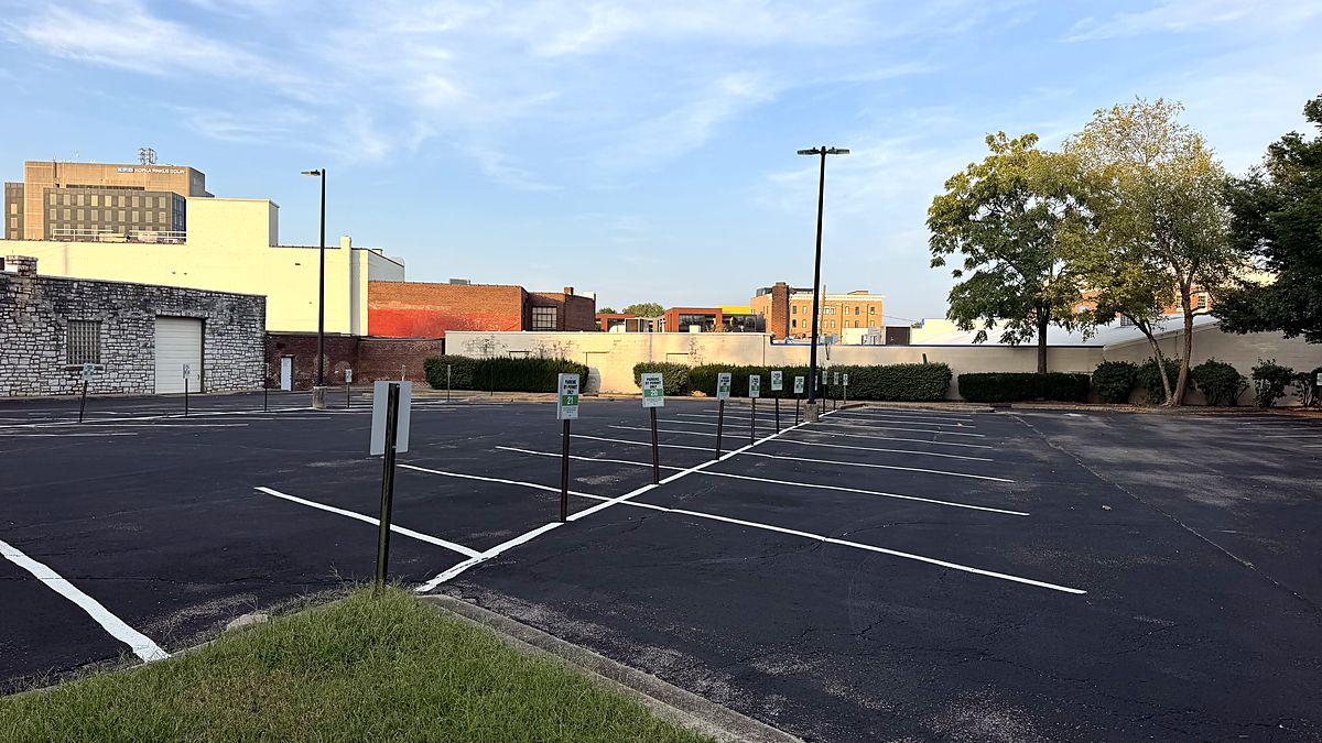 The lot at 315 E High St: freshly striped spaces with green permit signs